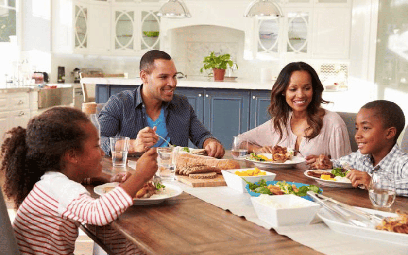 Family enjoying a meal together; reclaiming food freedom and joyful eating with Nutrition IQ